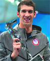 Phelps poses with the greatest Olympic athlete of all time trophy.