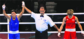 Mary Kom (L) is delcared the winner after her bout in London on Sunday.