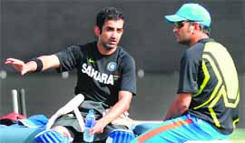 MS Dhoni (R) speaks with Gautam Gambhir during practice on Monday. 