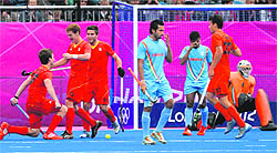 Belgian player Tom Boon (L) celebrates after scoring against India on Tuesday. Belgium won 3-0