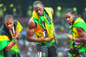 Jamaica's Usain Bolt (C) celebrates with Jamaica's Yohan Blake (R) and Jamaica's Warren Weir (L) after winning the men's 200m final. 