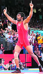 Yogeshwar Dutt celebrates his bronze medal win over North Korea�s Jong Myong RI on Saturday