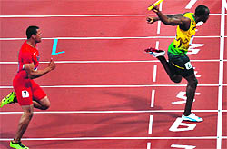 Jamaica's Usain Bolt and US' Ryan Bailey (L) compete in the men's 4X100 relay final in London on Saturday. Jamaica won the gold by setting a new world record (36.84s), while the USA got silver (37.04s) and Trinidad&Tobago won bronze (38.12s)