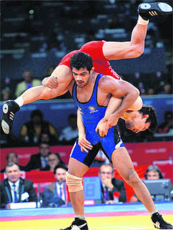 Sushil Kumar (in blue) lifts Kazakhstan�s Akzhurek Tanatarov in their 66kg semifinal in London on Sunday