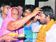 Yogeshwar is greeted by his mother Sushila Devi on Tuesday.