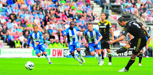 Chelsea's Frank Lampard (R) scores his team's second goal from a penalty during their match against Wigan Athletic in Wigan on Sunday. Chelsea won 2-0.