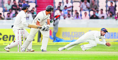 New Zealand's Ross Taylor (C) watches as Virat Kohli (R) dives to take a catch to dismiss him off the bowling of R Ashwin in Hyderabad on Friday.