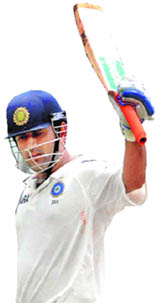 MS Dhoni raises his bat after completing his half-century in Hyderabad on Friday. 