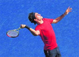 Roger Federer of Switzerland serves while practising at the USTA Billie Jean King National Tennis Center in New York City