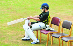 Sachin Tendulkar checks his bat at a practice session in Bangalore on Wednesday. 