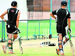 New Zealand�s Martin Guptill (L) and James Franklin watch their teammates during a practice session on Thursday