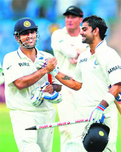 MS Dhoni and Virat Kohli celebrate after India completed the victory. 
