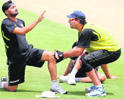 Comeback cricketers Harbhajan Singh and Yuvraj Singh stretch during training in Visakhapatnam on Friday. 