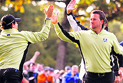 Europe�s Rory McIlroy and Graeme McDowell celebrate after winning a hole during the foursomes round at the Ryder Cup in Medinah, Illinois, on Friday