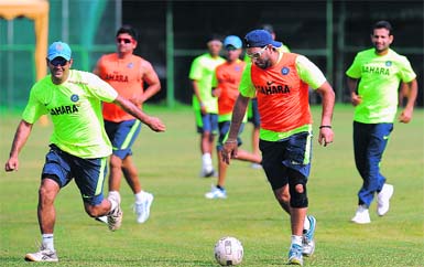 Skipper MS Dhoni (L) and Yuvraj Singh play football ahead of Super Eight tie against Pakistan in Colombo on Saturday. 