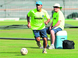 Duncan Fletcher keeps a close eye on MS Dhoni during a warm-up session in Colombo on Monday. 
