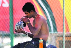 Sri Lanka�s Nuwan Kulasekara kisses his shoe during a training session