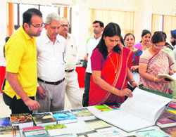 Vice-Chancellor Dr Pankaj Mittal and Registrar Dr Asha Kadiyan view  the books displayed at an exhibition at BPS Mahila Vishwavidyalaya, Khanpur Kalan. 