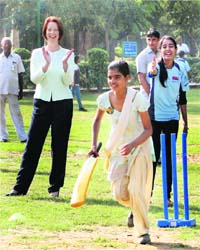 Australia Prime Minister Julia Gillard watches a girl play during a visit to a cricket camp for underprivileged children in New Delhi on Tuesday