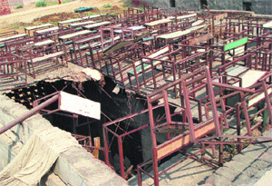 The collapsed roof of a primary school building in Shakti Nagar, Kaithal, and broken benches kept on roof. 