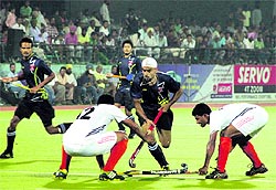 ONGC and Bharat Petroleum players in action during their semifinal clash of the Surjit Singh Memorial Hockey Tournament in Jalandhar on Thursday. Bharat Petroleum won the match 12 -11 through a tie-breaker
