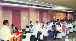 Additional Labour Commissioner Naresh Narwal addresses a conference of industrialists in Rewari. Photo: Nawal Kishore Rastogi
