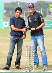 Red Bull driver Mark Webber shakes hands with Gautam Gambhir on Wednesday. 
