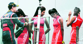 Naughty Sebastian sprays bubly on grid girls