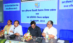The CMD of Haryana Bijli Vitran Nigam, Devender Singh (second from left), listens to public grievances in an open durbar at GVM Girls College, Sonepat. Photo by writer