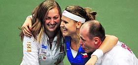 Czech Republic�s Lucie Safarova (C) is congratulated by Petra Kvitova and captain Petr Pala after she ensured the Fed Cup title for her team.