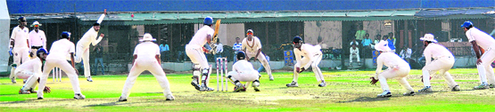 The victorious Punjab team surrounds Hyderabad�s last batsman on Monday. � Tribune photo: Vicky Gharu