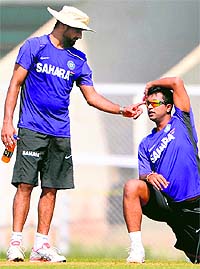 Off-spinner Harbhajan Singh and left-arm spinner Pragyan Ojha share a joke during a practice session in Mumbai on Sunday