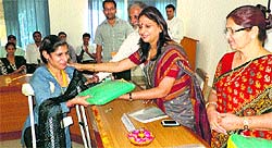 BPS Women University Vice-Chancellor Pankaj Mittal presents uniform to a differently abled student of the Women Polytechnic