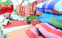 Workers give final touches to a quilt in Karnal