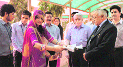 An NSS volunteer from Rajasthan welcomes the Vice-Chancellor, HS Chahal, and Registrar RK Arora during the inaugural ceremony of the nine-day pre-Republic Day NSS camp on the Murthal university premises. Photo by writer