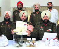 Police displays the weapons and drugs seized in Rajpura on Friday.