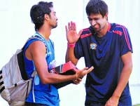 Rahul Sharma shares a joke with Saurashtra�s Jaidev Unadkat ahead of their match. Tribune photo: Vicky Gharu