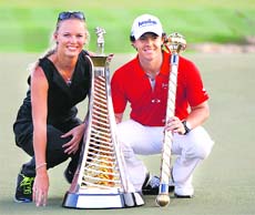 Rory McIlroy of Northern Ireland poses with the trophy and his girlfriend Caroline Wozniacki after the fourth and final round of the DP World Tour Championship at Jumeirah Golf Estates in Dubai. 