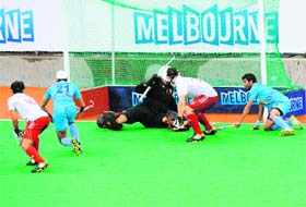 Gurwinder Chandi (L) scores off a penalty corner in Melbourne on Saturday