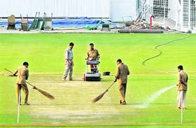 Groundsmen at work at the Eden Gardens cricket ground in Kolkata on Saturday