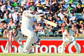 Graeme Smith hits a four during his innings of 84 as former Australian captain Ricky Ponting looks on in Perth on Saturday