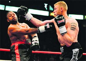 Andrew Flintoff (R) lands one on Richard Dawson during their bout in Manchester on Friday night
