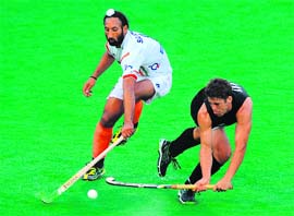 India�s Sardar Singh vies with Nicholas Wilson of New Zealand in Melbourne on Sunday