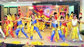 In all their finery: Schoolchildren perform during the annual function at Blue Bells in Gurgaon