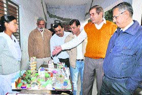 Education officials inspect models made by school students at a science and environment exhibition at Government Senior Secondary School, Jhajjar