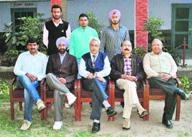The college principal, Dr Vinay Malhotra, and other faculty members with athletes (standing) of Markanda National College, Shahabad-Markanda