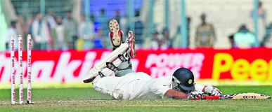 Cheteshwar Pujara makes a desperate effort to complete a run on Day 4 of the third Test in Kolkata on Saturday.