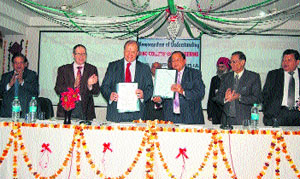 Prof Martyn Kendrick from De Montfort University and Chairman of the management committee of NC College of Engineering, DV Gupta, present the signed copies of the MoU on the college campus.
