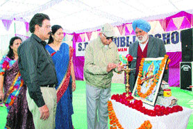 Dr JR Siwach lights the ceremonial lamp to inaugurate the annual function of Baba Deep Singh Public School while Dr Virender Siwach, Sharanjit Kaur and Dr Anuradha Siwach look on.