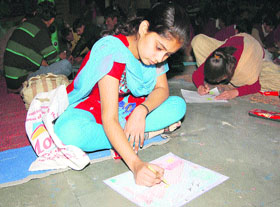 A girl with hearing and speech disabilities draws a painting in Sirsa.